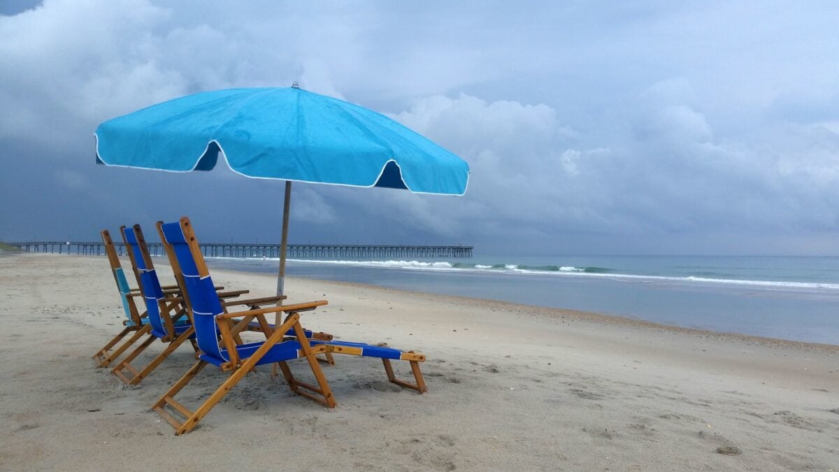 Rain Storm at the Beach, Topsail Island, NC - blue beach chairs and umbrella against blue sky ocean
