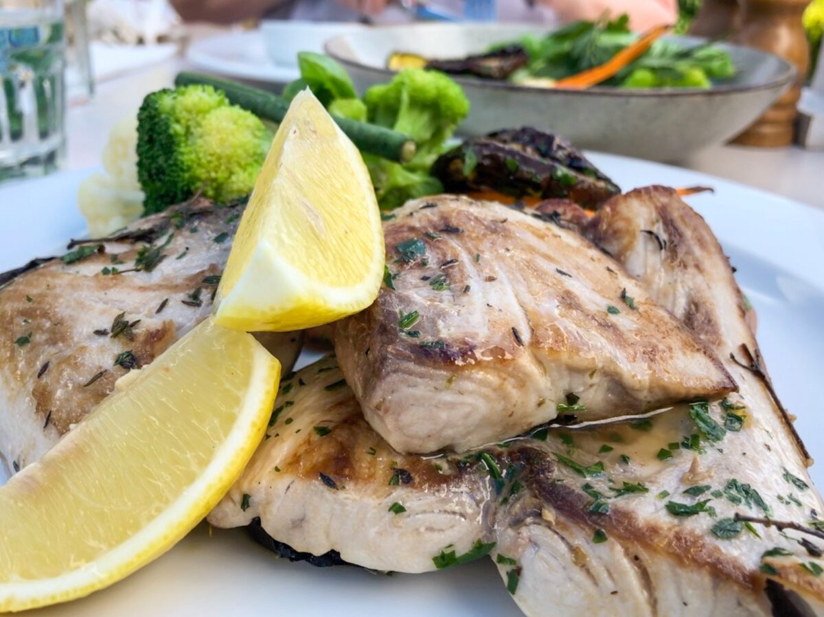Perfectly cooked Mahi Mahi just off the grill, served with lemon wedges, and crisp, steamed veggies.