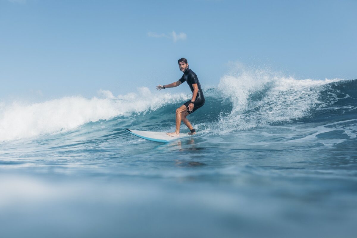 sports man surfing wave on surf board in ocean